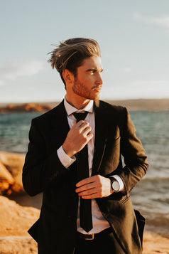 Shadow tie worn with a white shirt, black belt and black suit.