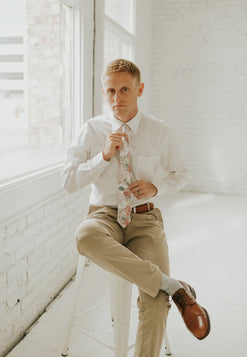 Smitten tie worn with a white shirt, brown belt and khaki pants.