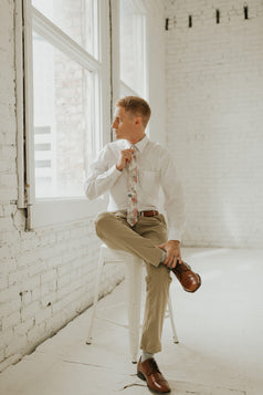 Smitten tie worn with a white shirt, brown belt and khaki pants.