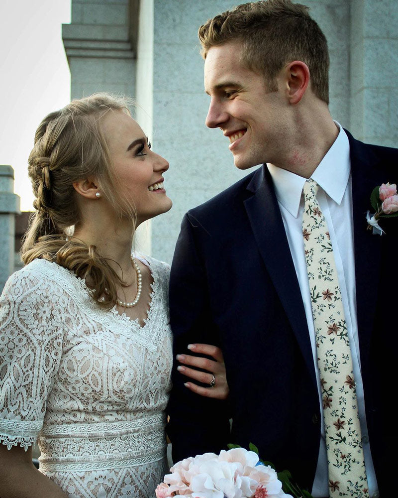 Sugar Blossom tie worn by a groom at a wedding with a white shirt and dark navy suit jacket.