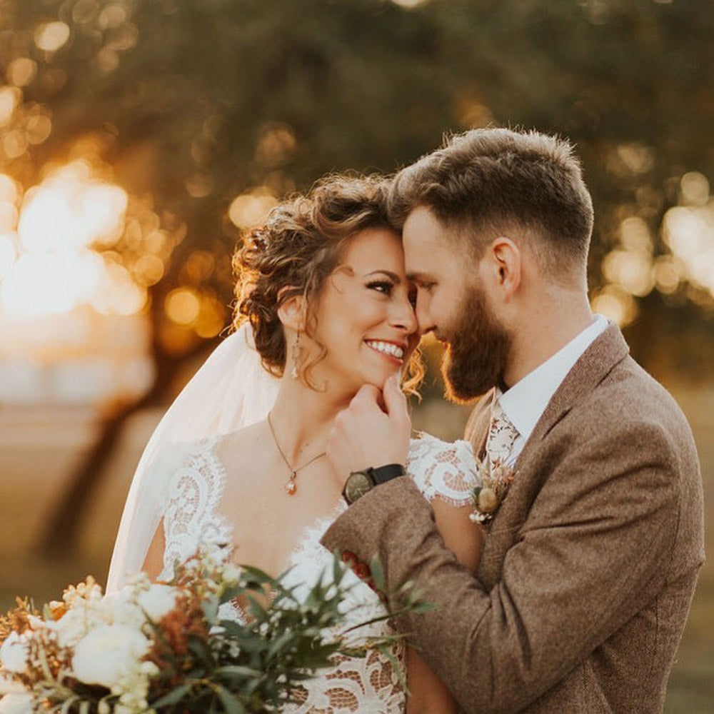 Sugar Blossom tie worn by a groom at a wedding with a white shirt and brown textured suit jacket.